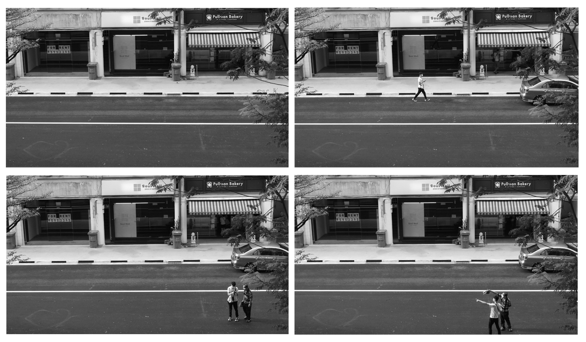 A sequence of four black and white photos. The first image shows an empty street. The second image is a single man walking from left to right at the top frame of the street. The third photo he is at the bottom frame talking to an elderly woman. In the last frame, they are both facing left and pointing in that direction.